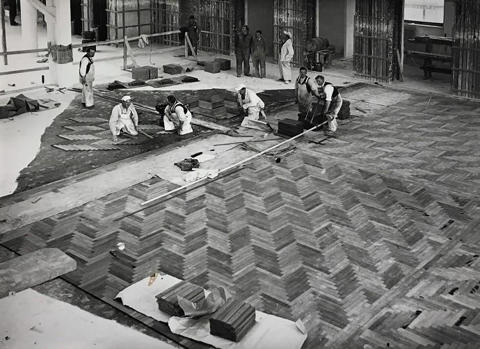 Hustømrerne i færd med at lægge gulvet på Aarhus Rådhus tilbage i 1939-1940. Sildebensmønstret er af moseeg.